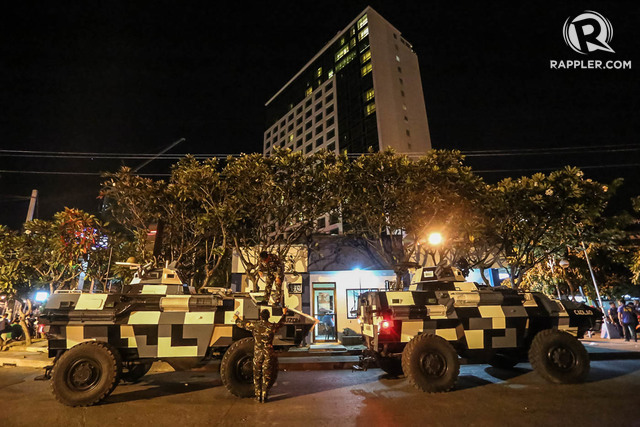 JOINT FORCES. PSG armored personnel carriers guard the Marco Polo Hotel.   