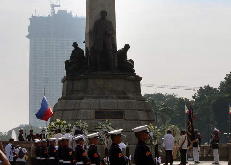 NATIONAL PHOTOBOMBER. Manila officials commemorate national hero Jose Rizal's  birth anniversary at Luneta Part, with the Torre de Manila looming behind the Rizal monument. Photo by Joel Leporada/Rappler  