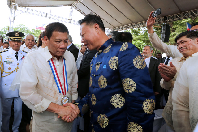 DUTERTE'S CHINA PIVOT. On National Heroes' Day, President Rodrigo Duterte shakes hands with Chinese Ambassador Zhao Jinhua. Photo from PPD  