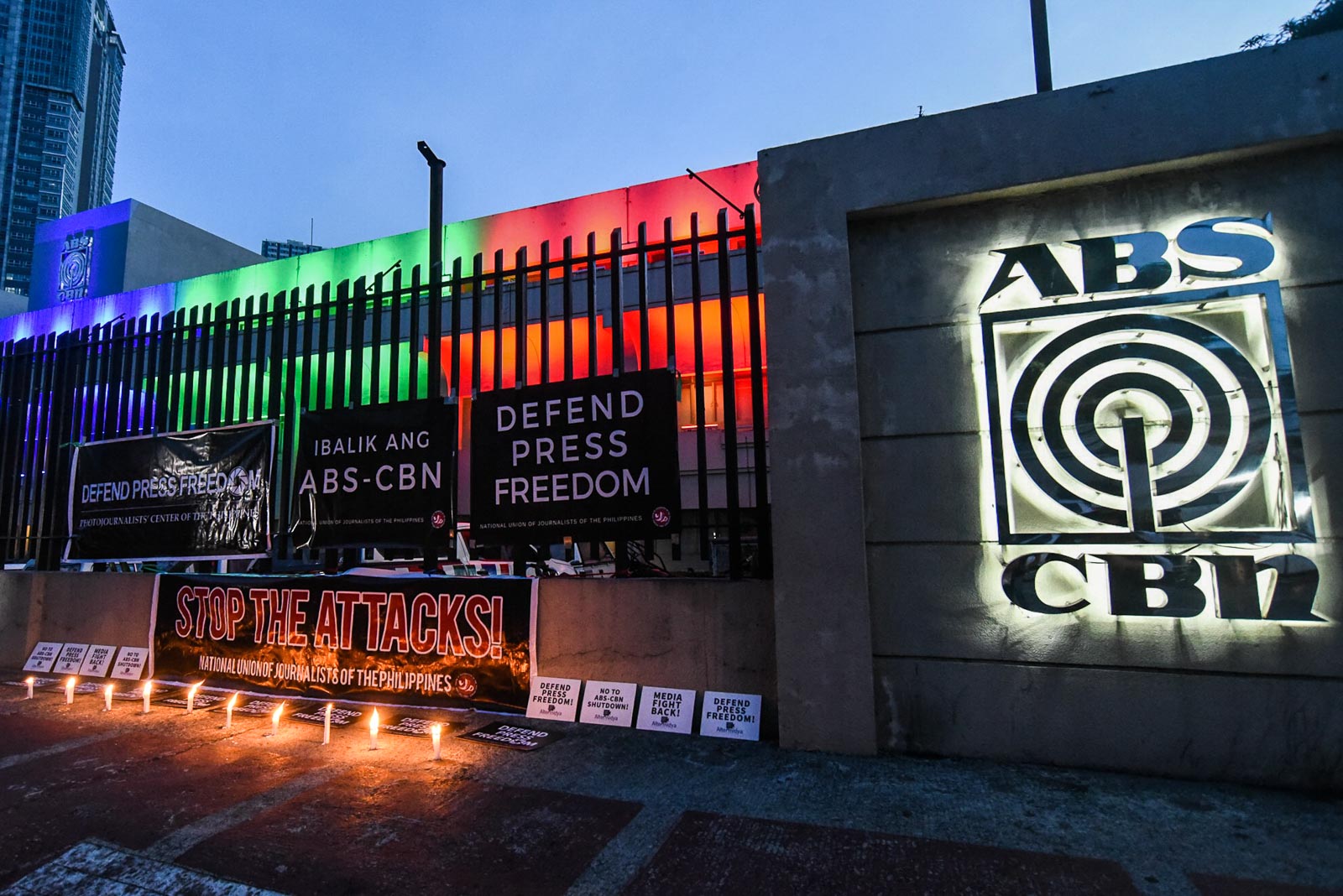 'STOP THE ATTACKS.' Members of the National Union of Journalists of the Philippines and the Photojournalists' Center of the Philippines hold a candle-lighting protest outside the ABS-CBN compound on July 3, 2020. Photo by Angie de Silva/Rappler 