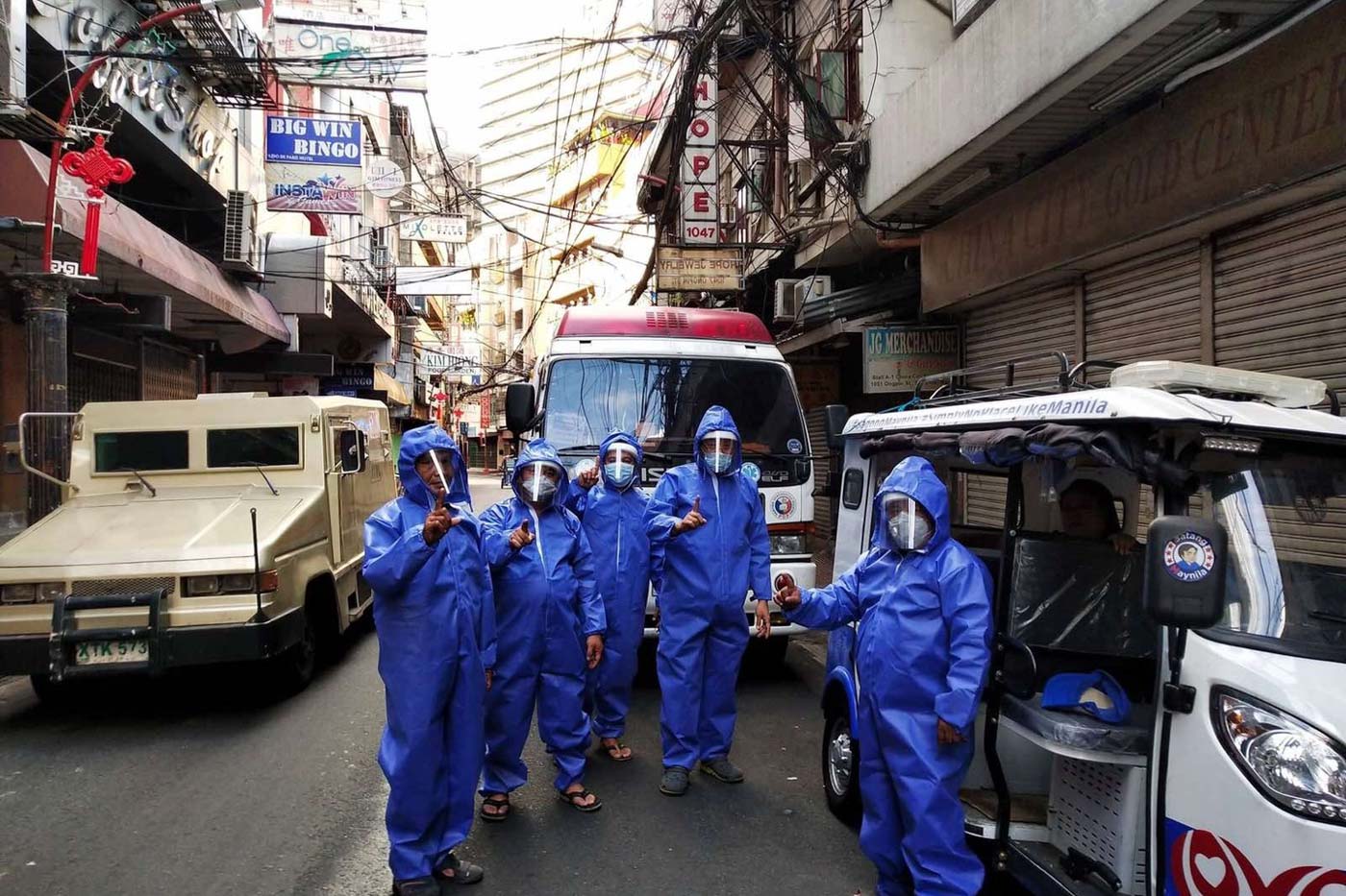 REUSABLE. Firefighters, who also help administer disinfection and community feeding programs, in reusable protective coveralls in Tondo, Manila. Photo by Crispian Lao/PARMS  