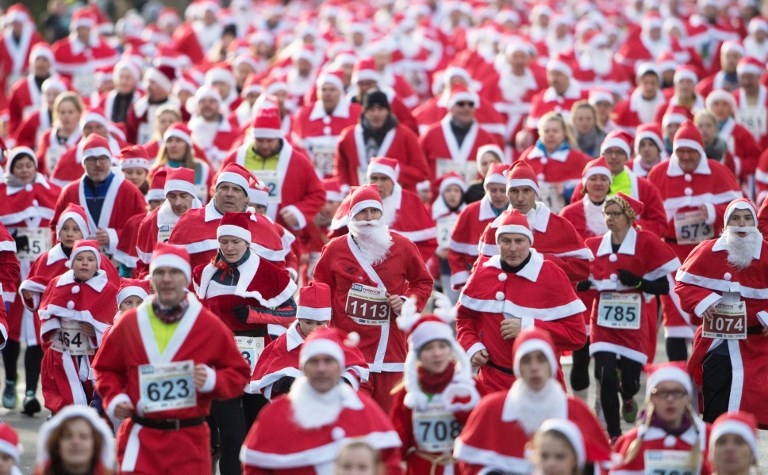 SANTA RUN. Participants dressed in Father Christmas costumes take part in the traditional Santa Claus run in Michendorf, Germany, on December 10, 2017. Photo by Ralf Hirschberger/DPA/AFP 