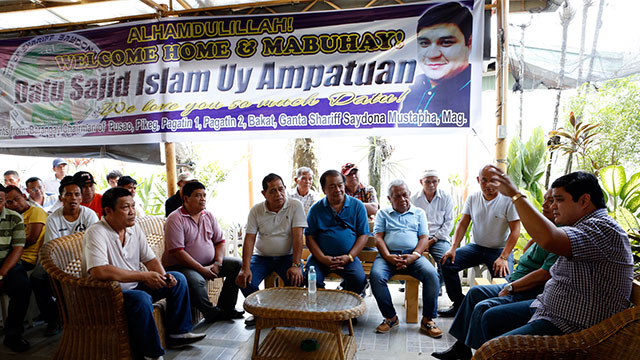 BACK HOME. Sajid Islam Ampatuan, son of former Maguindanao governor Andal Ampatuan Sr. (extreme right) who was granted bail on January this year by Regional Trial Court Branch 221 Judge Jocelyn Solis-Reyes in connection with the November 2009 Maguindanao massacre, speaks to their family's supporters as he returned home in Cotabato City, May 10, 2015 after 5 years in prison. 