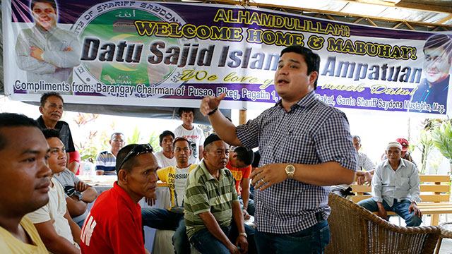 WELCOME HOME. Sajid Islam Ampatuan, son of former Maguindanao governor Andal Ampatuan Sr. (extreme right) who was granted bail on January this year by Regional Trial Court Branch 221 Judge Jocelyn Solis-Reyes in connection with the November 2009 Maguindanao massacre, speaks to their family's supporters as he returned home in Cotabato City, May 10, 2015 after five years in prison. All photos by Jef Maitem 