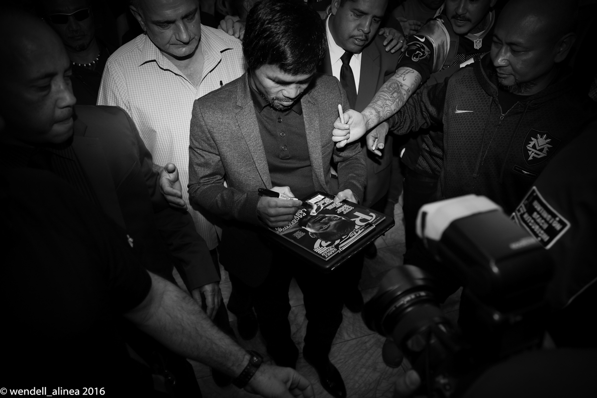 Manny Pacquiao signs a copy of The Ring magazine for a fan. Photo by Wendell Alinea 
