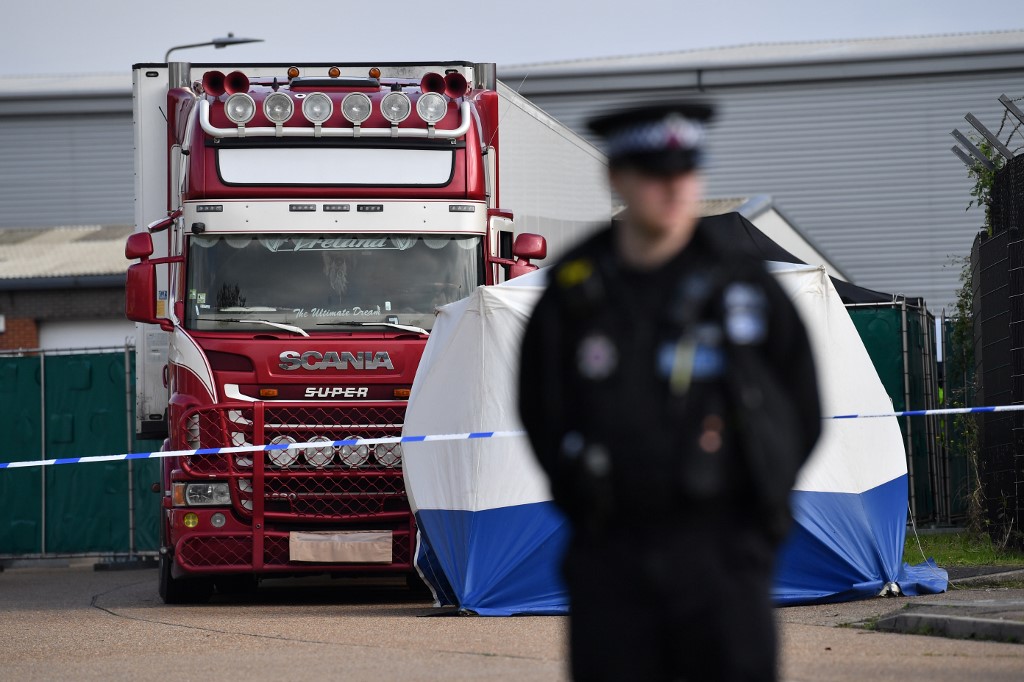 A police officer secures the cordon at at the scene where a truck, believed to have originated from Bulgaria, and found to be containing 39 dead bodies, was discovered at Waterglade Industrial Park in Grays, east of London, on October 23, 2019. Photo by Ben Stansall/AFP 