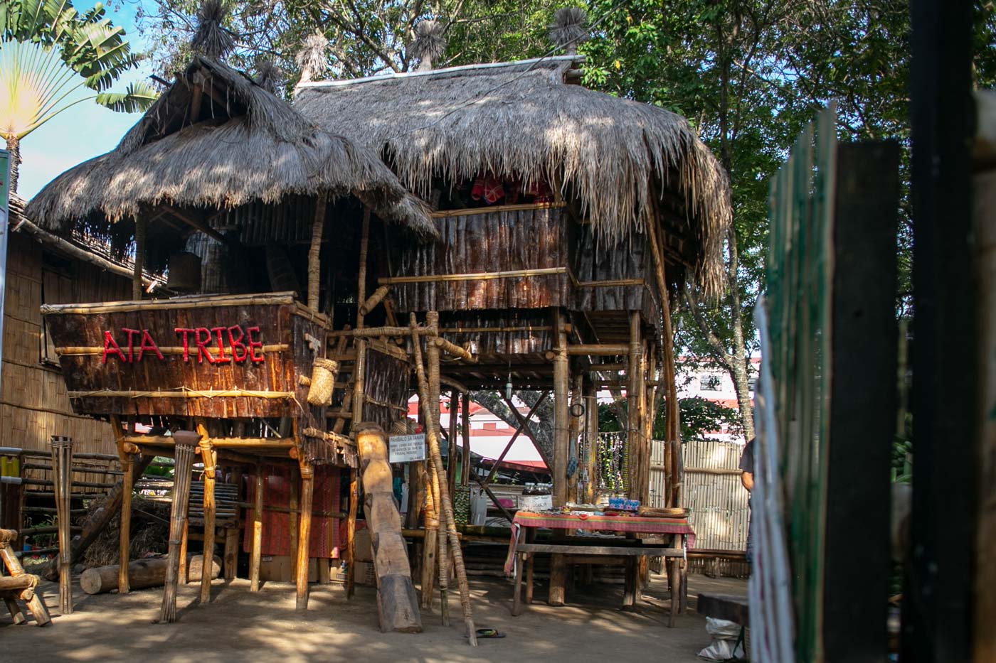 The tribal house of the Ata tribe has walls made from tree bark and stairs carved from a single piece of log.
 