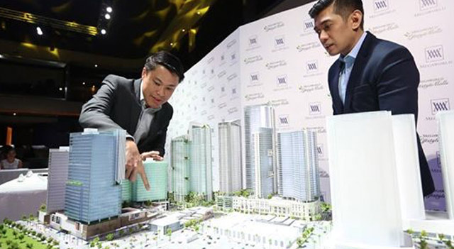 NEW MALLS. Megaworld first vice president Kevin L. Tan (left) presents to the media on Tuesday, August 18, 2015, the scale model of Megaworld’s Uptown Bonifacio township, housing the Uptown Place and Uptown Parade malls. Photo from Megaworld's Facebook page