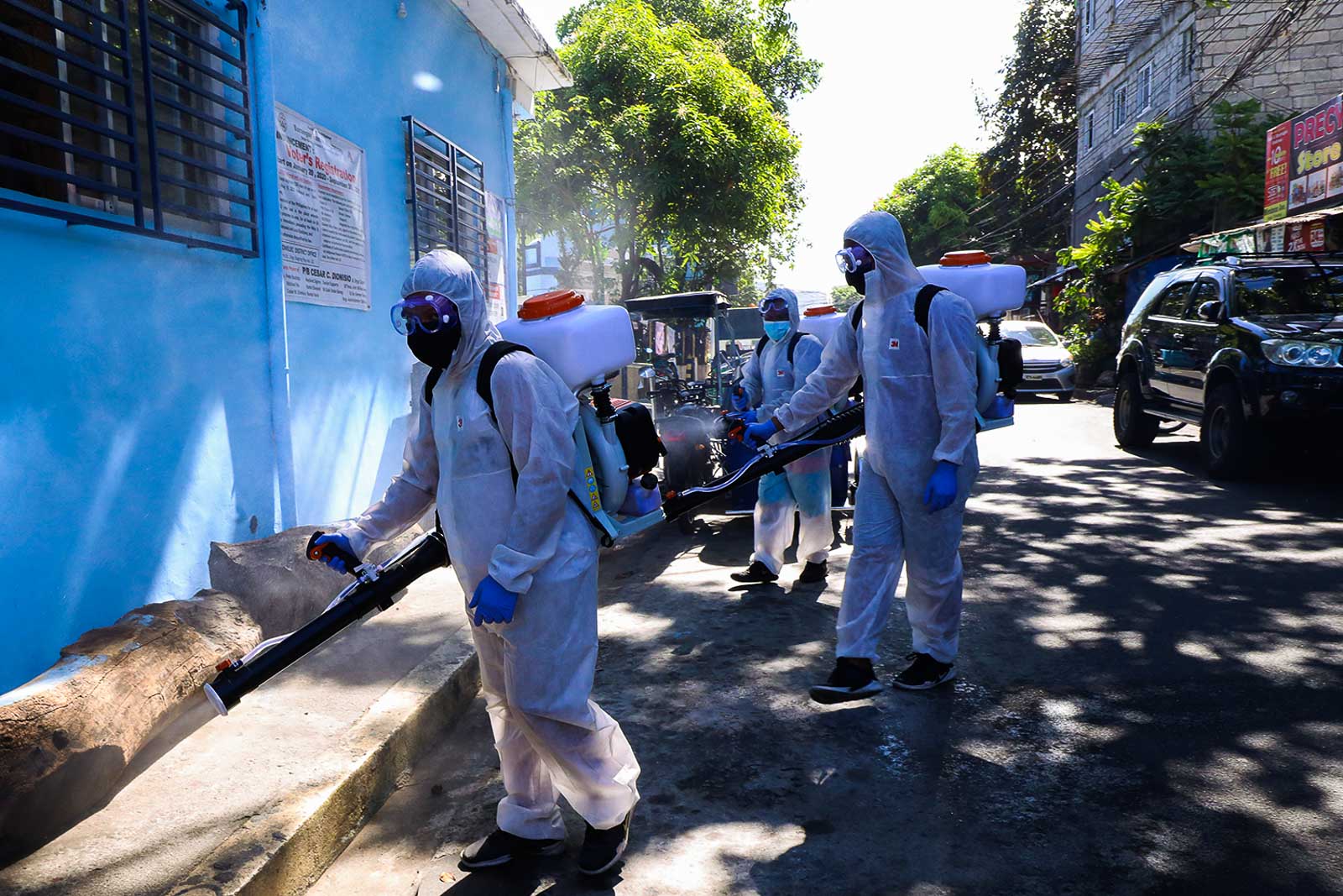 NO LOCKDOWN YET. Quezon City Health workers disinfect the surroundings of a barangay. File photo by Darren Langit/Rappler 