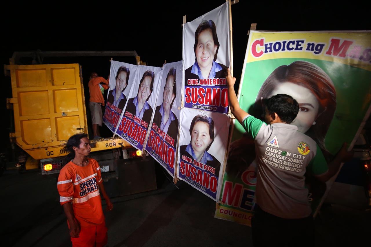 TAKE DOWN. Local government workers start early to remove illegal campaign posters all over Quezon City during their Task Force Tear Down on Friday, March 1, 2019. Photo by Ben Nabong/Rappler  