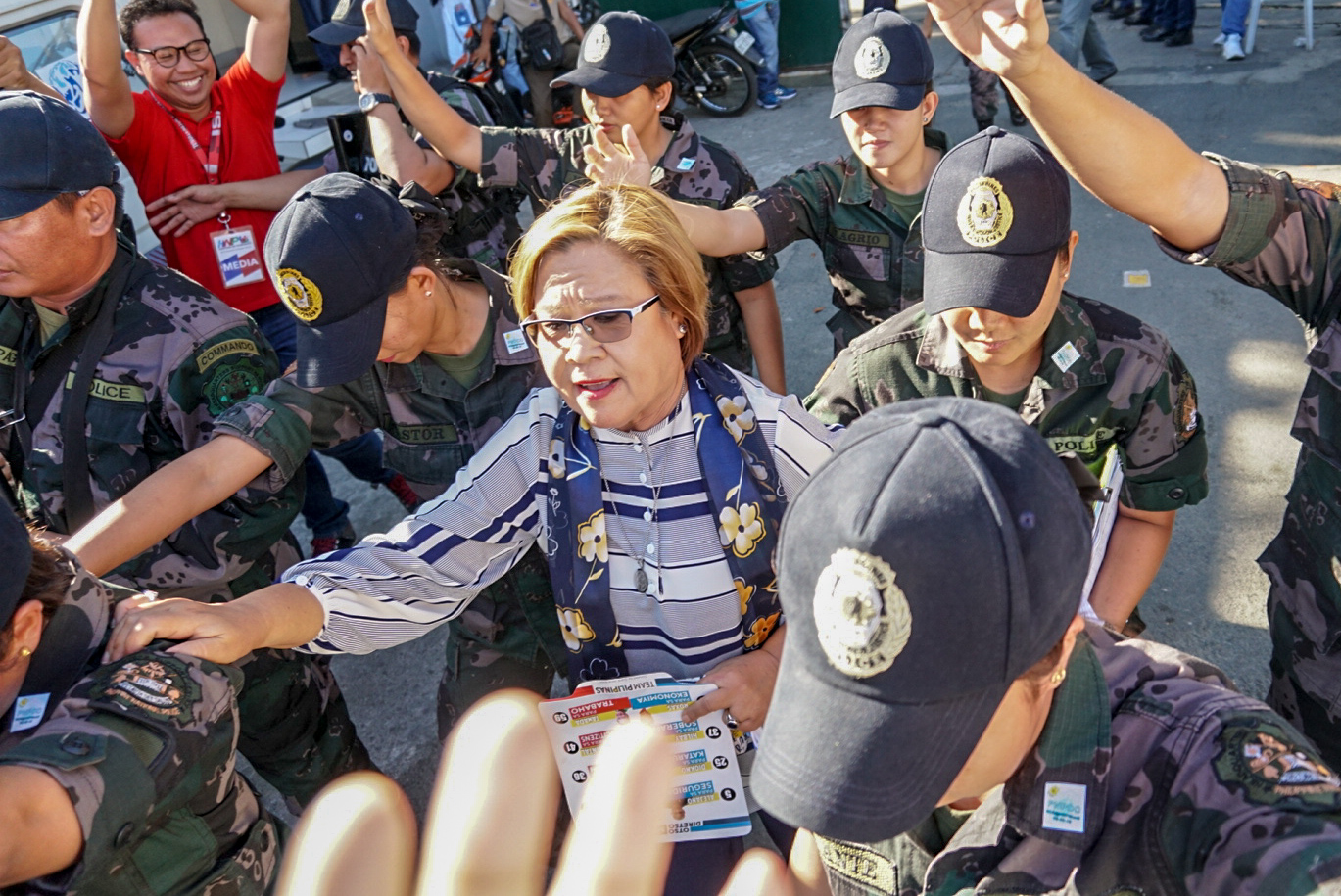DETAINED. Senator Leila de Lima is escorted by police officers as they leave the court. File photo by Lito Borras/Rappler 