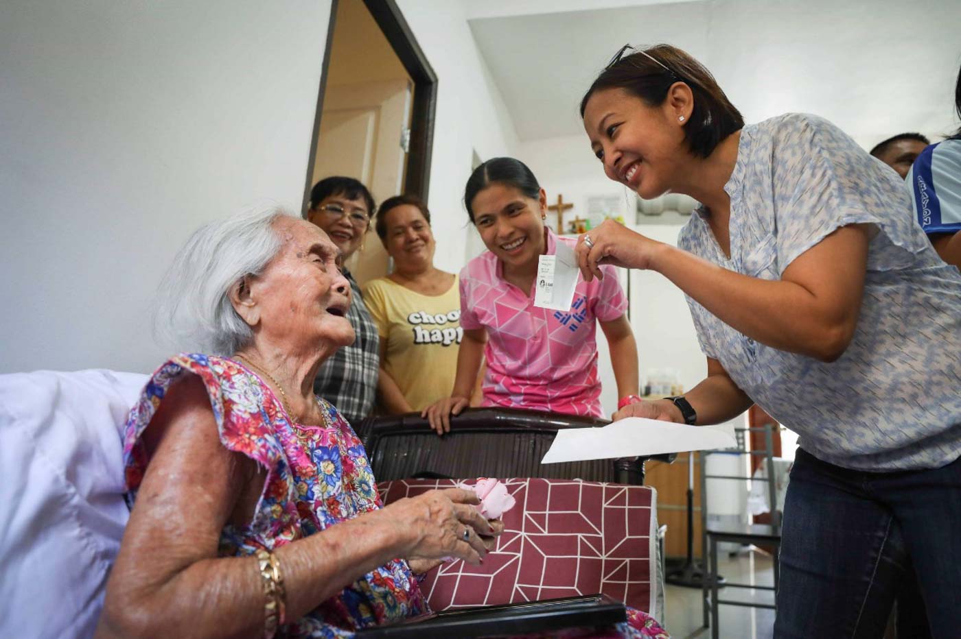 STILL LIKE HER FATHER. Mayor Abby Binay and Vice Mayor Monique Lagdameo personally hand a P100,000 check to Andresa Caparos, a centenarian living in Makati. Photo from the Makati City government 