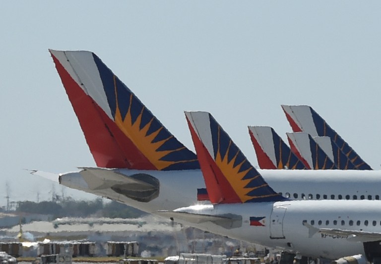 REGULATORY CONFLICT. This photo taken on January 26, 2016 shows tail sections of Philippine Airlines (PAL) aircraft while parked at the Ninoy Aquino International Airport (NAIA) Terminal 2. File photo by Ted Aljibe/AFP  