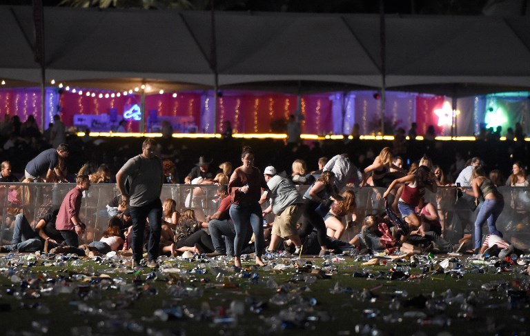 MAD SCRAMBLE. People run from the Route 91 Harvest country music festival after apparent gun fire was heard on October 1, 2017 in Las Vegas, Nevada. David Becker/Getty Images/AFP 
