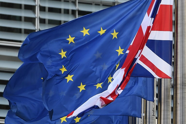 BREXIT. A Union Jack hangs down next to European Union flags fluttering in front of the European Commission building. File photo by Emmanuel Dunand/AFP 