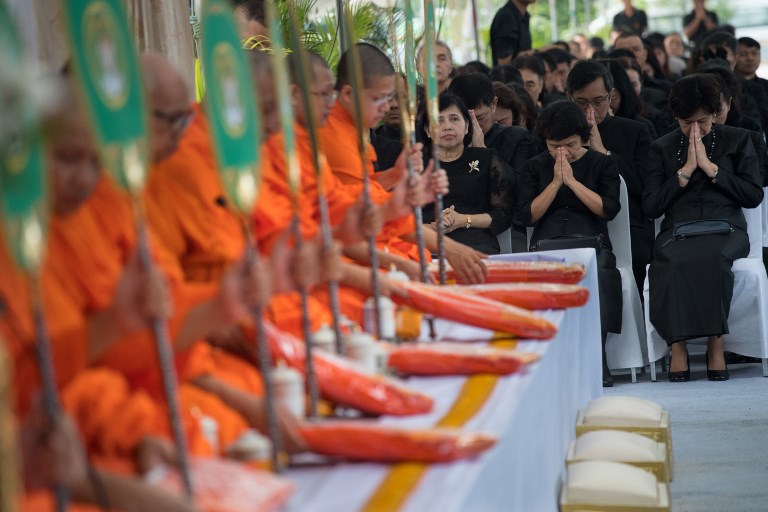 ONE YEAR. People clad in black in a sign of mourning pray as they listen to Buddhist monks chant mantras during a ceremony led by monks in front of Bangkok's City Hall on October 13, 2017, marking one year since the death of King Bhumibol Adulyadej.
Photo by Roberto Schmidt/AFP 