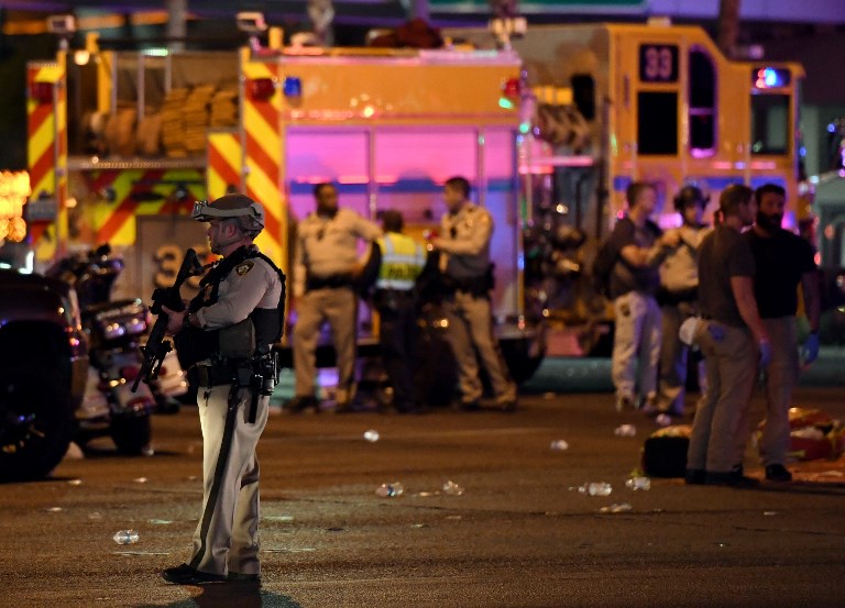 In this file photo, a Las Vegas Metropolitan Police Department officer stands in the intersection of Las Vegas Boulevard and Tropicana Ave. after a mass shooting at a country music festival nearby on October 2, 2017 in Las Vegas, Nevada. Ethan Miller/Getty Images/AFP 