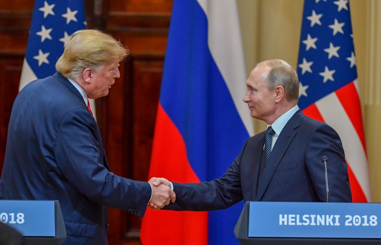 SHAKING HANDS. US President Donald Trump (L) and Russia's President Vladimir Putin shake hands before attending a joint press conference after a meeting at the Presidential Palace in Helsinki, on July 16, 2018. Photo by Yuri Kadobnov/AFP 