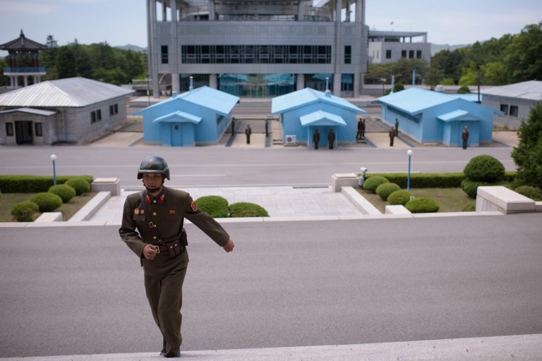THE KOREAS. In this photo taken on June 2, 2017, a North Korean soldier walks up steps toward Panmon hall on the north side of the truce village of Panmunjeom, before the South Korea and US-controlled Freedom House (rear) within the Demilitarized Zone (DMZ) separating North and South Korea. File photo by Ed Jones/AFP 