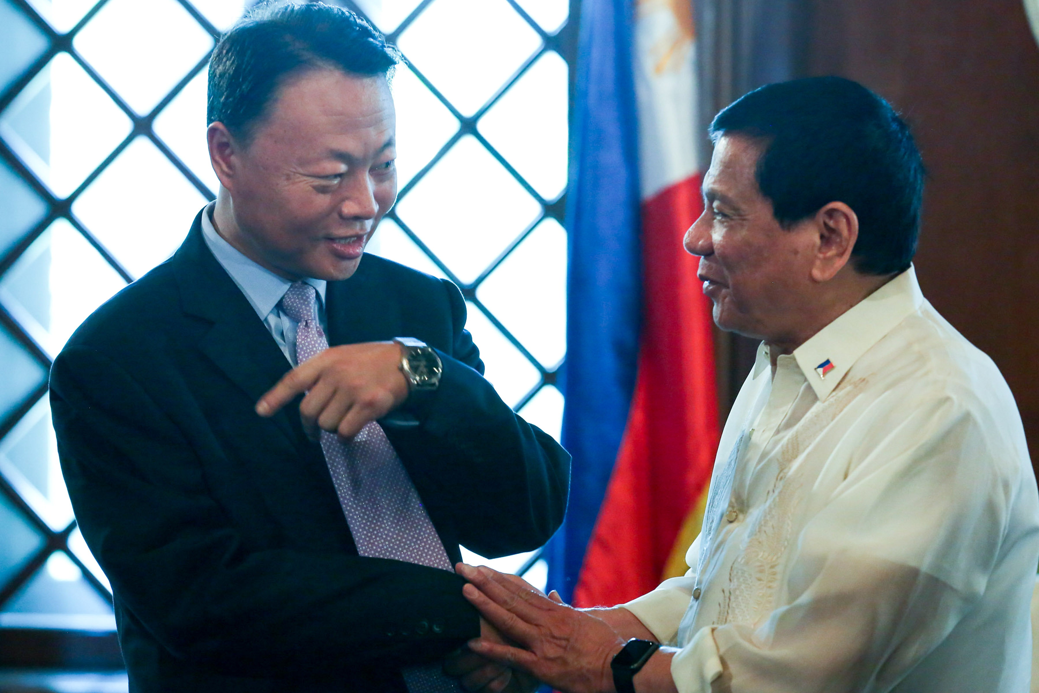 BOOSTING TIES. President Rodrigo Duterte shakes hands with Chinese Ambassador to the Philippines Zhao Jianhua during a meeting in Malacañang. Malacañang file photo  