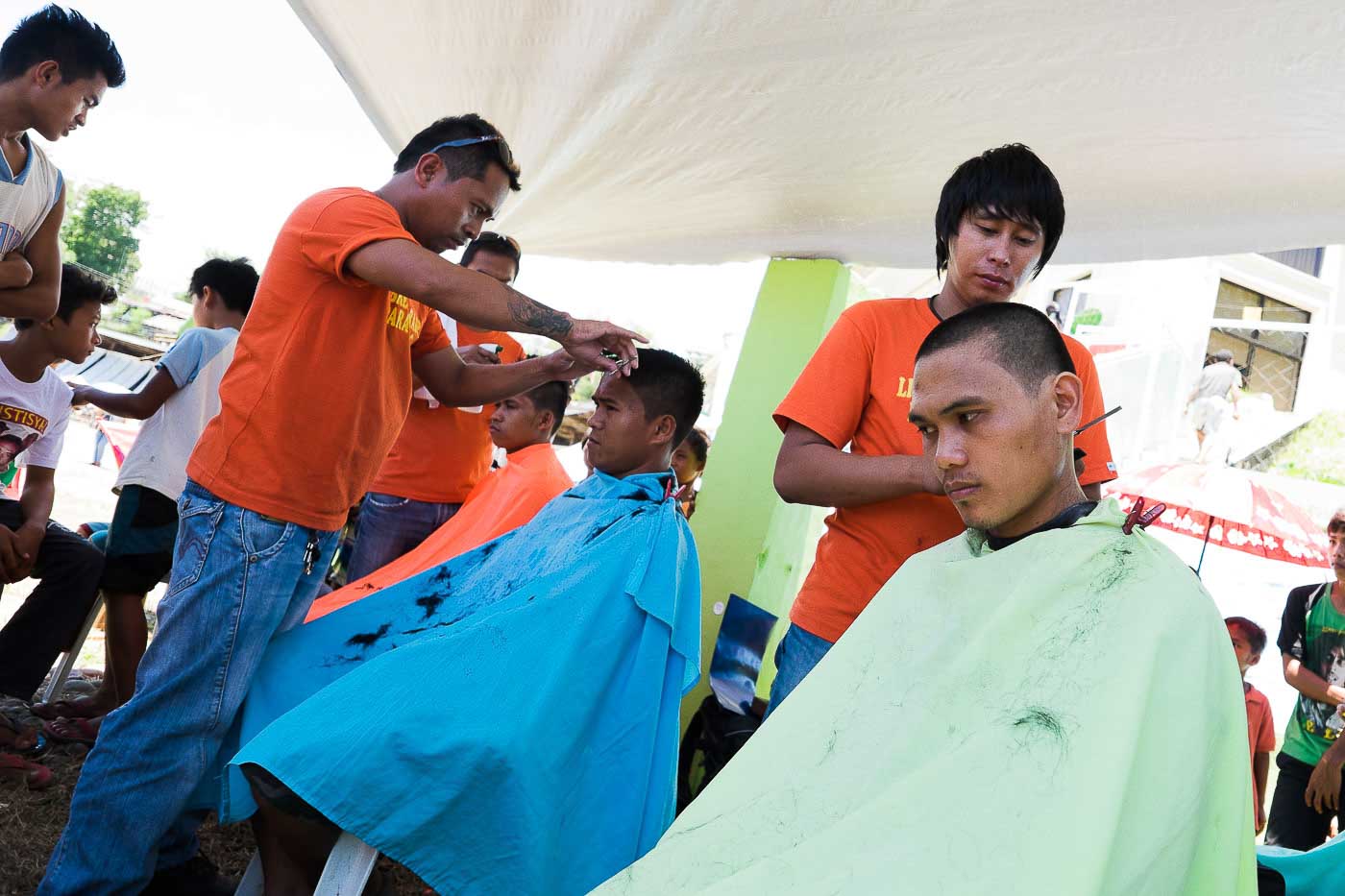 THE MEN. Getting haircuts at the Tandag City Sports Complex where almost 4,000 Lumads have been staying since September 1.