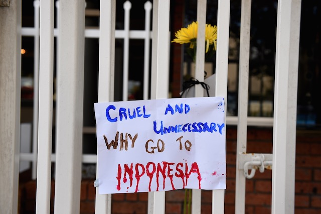 'WHY GO?' A hand painted sign left is seen outside the Indonesian Consulate in Maroubra, Sydney, Australia, April 29, 2015. Dan Himbrechts/EPA 