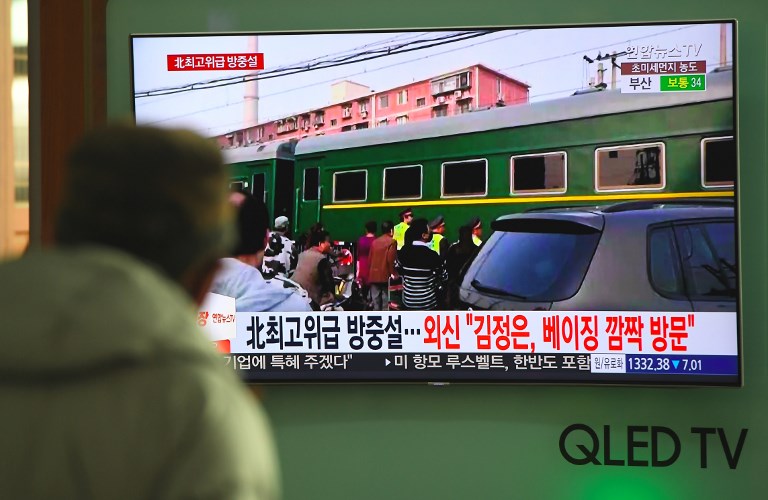 KIM JONG-UN VISIT? A man watches a television news report about a suspected visit to China by North Korean leader Kim Jong Un, at a railway station in Seoul on March 27, 2018. Photo by Jung Yeon-je/AFP 