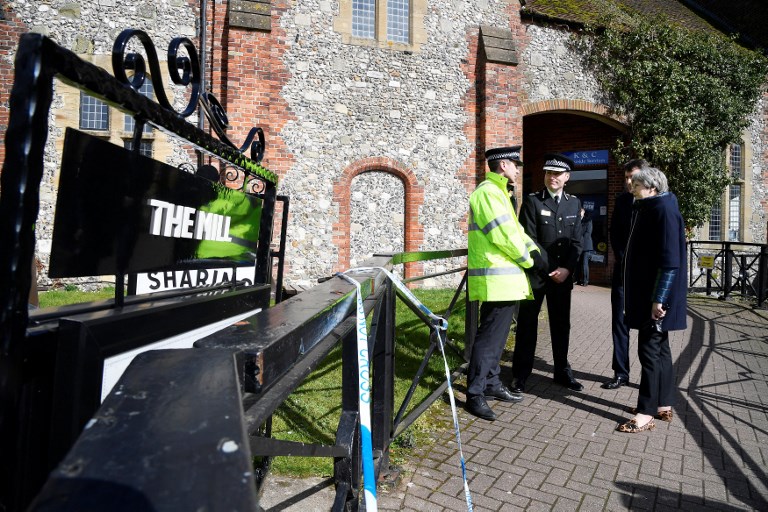 NOVICHOK ATTACK. Britain's Prime Minister Theresa May (R) talks with Wiltshire Police's Chief Constable Kier Pritchard (2L) as they stand near The Mill Pub in Salisbury, southern England, on March 15, 2018, where former Russian double agent Sergei Skripal and his daughter Yulia went before being discovered on a nearby bench on March 4, following an apparent nerve agent attack. File photo by Tony Melville/AFP 