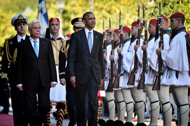 US President Barack Obama and his Greek counterpart Prokopis Pavlopoulos (L) review a presidential honor guard during the official welcoming ceremony at the presidential palace in Athens on November 15, 2016. Louisa Gouliamaki/AFP 