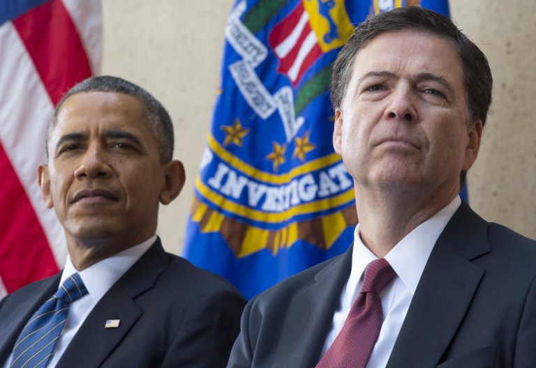 In this file photo, US President Barack Obama sits alongside new FBI Director James Comey (R) during an installation ceremony at Federal Bureau of Investigation Headquarters in Washington, DC, October 28, 2013. Saul Loeb/AFP 