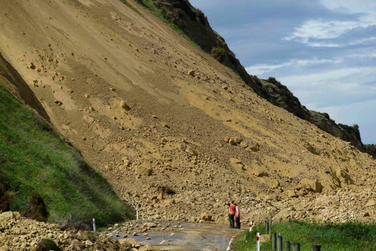 Emergency services officers inspect the damage caused to Rotherham Road near Waiau town, some 90 kms to the south of Kaikoura, on November 16, 2016, after an earthquake hit New Zealand just after midnight on Monday. Matias Delacroix/AFP 