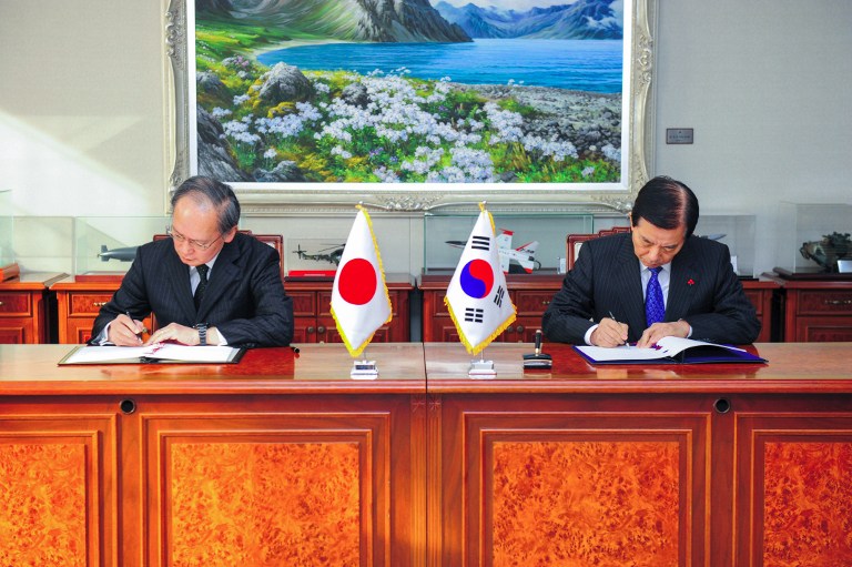 This handout photo taken on November 23, 2016 and released by South Korea's Defense Ministry shows South Korean Defense Minister Han Min-Koo (R) and Japanese Ambassador to Seoul Yasumasa Nagamine (L) during a signing ceremony of the General Security of Military Information Agreement (GSOMIA) at the defense ministry in Seoul. South Korea Defense Ministry/Handout/AFP 