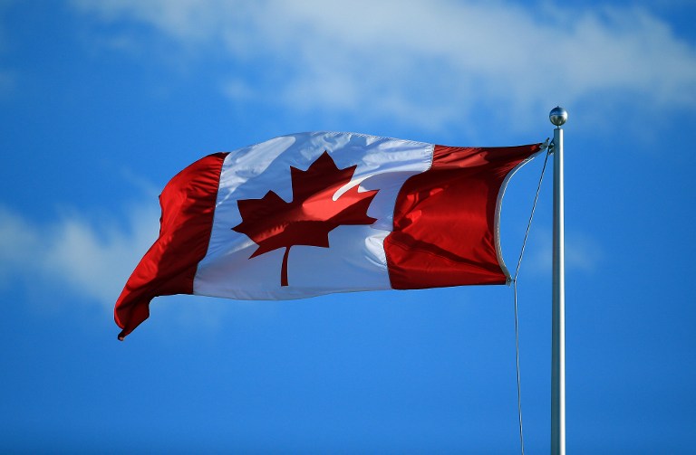 A Canada flag flies in the wind at the Aviva Centre on July 25, 2016 in Toronto, Ontario, Canada. Vaughn Ridley/Getty Images/AFP 