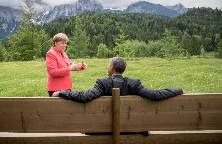 In this file photo, Germany's Chancellor Angela Merkel (L) gestures while chatting with US President Barack Obama sitting on a bench outside the Elmau Castle after a so-called outreach meeting at a G7 summit near Garmisch-Partenkirchen, southern Germany, on June 8, 2015. Michael Kappeler/Pool/AFP 