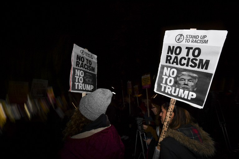 Demonstrators hold placards that read 'No to racism, no to Trump' during a protest outside the US Embassy in London on November 9, 2016 against US President-elect Donald Trump after he was declared the winner of the US presidential election. Ben Stanstall/AFP 