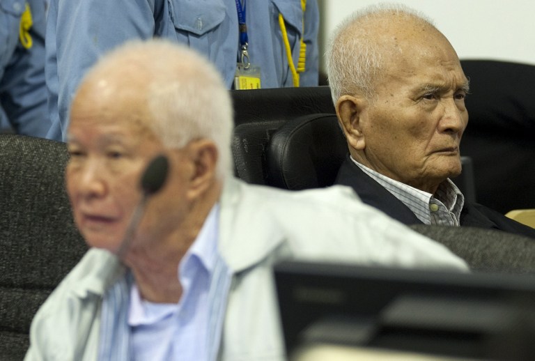 GUILTY. This handout photo taken and released by the Extraordinary Chamber in the Courts of Cambodia (ECCC) shows former Khmer Rouge leader head of state Khieu Samphan (L) and 'Brother Number Two' Nuon Chea (R) in the courtroom at ECCC in Phnom Penh on October 31, 2013. File photo by Mark Peters/ECCC/AFP  