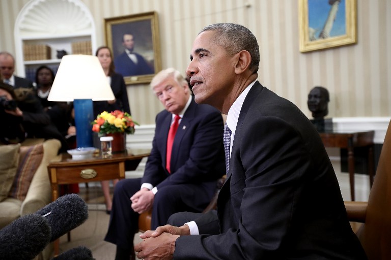 President-elect Donald Trump (L) listens as U.S. President Barack Obama speaks during a meeting in the Oval Office November 10, 2016 in Washington, DC. Win McNamee/Getty Images/AFP 