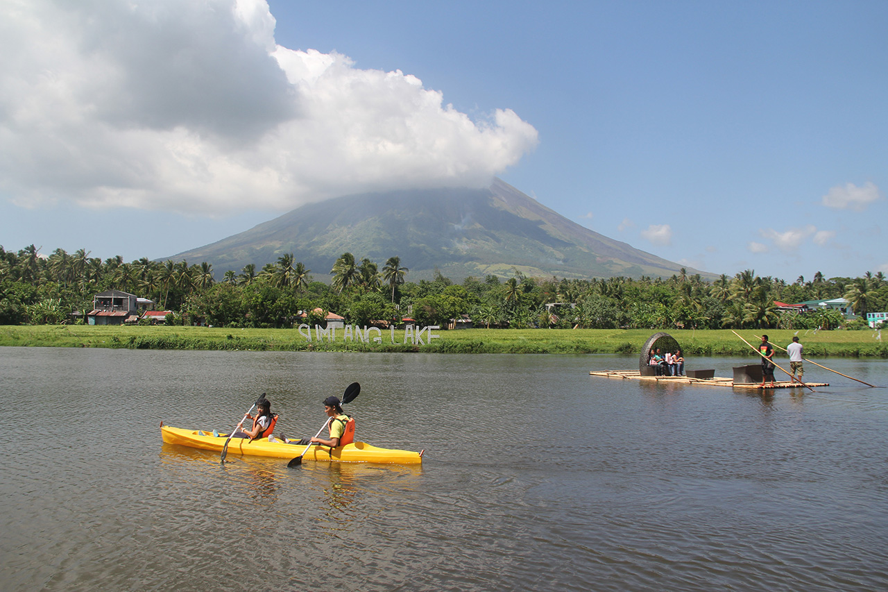 NATURE AND TOURISM. Tourists at Albay's Lake Sumlang, with the Mayon Volcano as the backdrop. Photo by Rhaydz B Barcia 