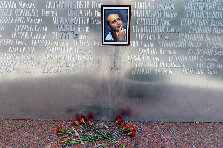 MEMORIAL WALL. Flowers lay under a picture of the 41-year-old anti-Kremlin reporter Arkady Babchenko on the memorial wall of Moscow's journalists house in Moscow on May 30, 2018. Photo by Vasily Maximov/AFP  