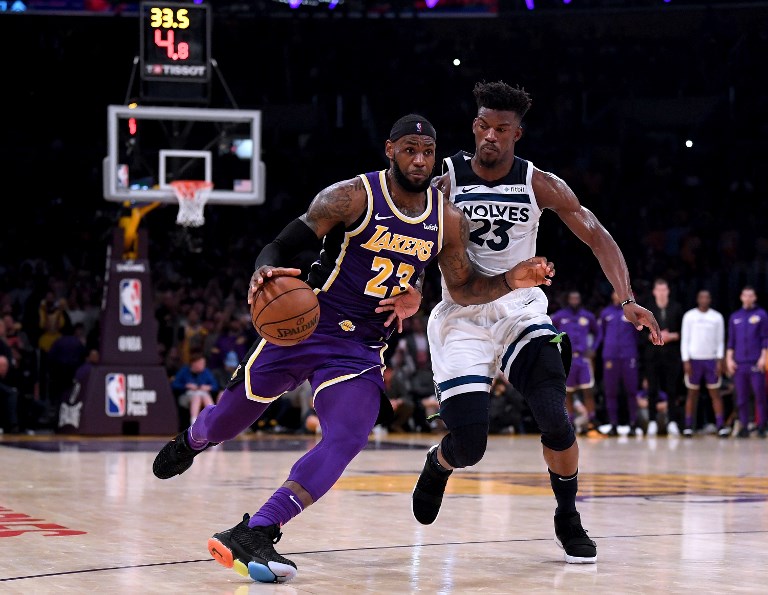 GRITTY WIN. Los Angeles superstar LeBron James drives to the basket past Minnesota's Jimmy Butler in the thriller won by the Lakers. Photo by Harry How/Getty Images/AFP  