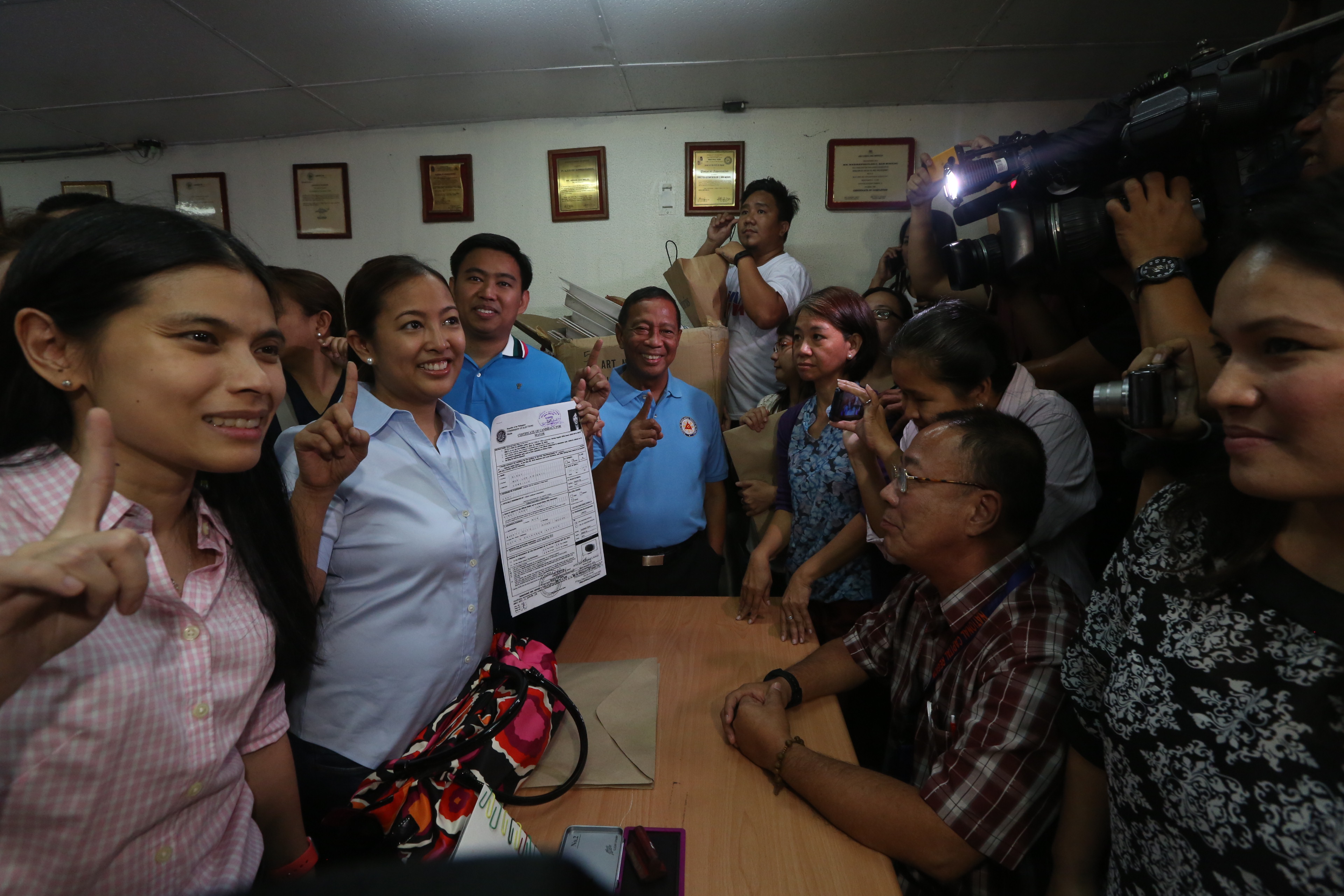 MAYORAL BID. If Makati Representative Abigail Binay (middle, holding COC) is elected as mayor, her family will retain political control of the city which it has held since 1986. Photo by Office of the Vice President Media Affairs 