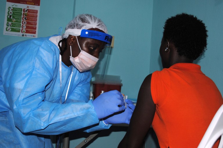 VACCINE TRIAL. An adhesive bandage is placed on the arm of a volunteer after she was administered an experimental Ebola vaccine at Redemption Hospital in New Kru Town, a suburb of Monrovia, on February 2, 2015. Zoom Dosso/AFP