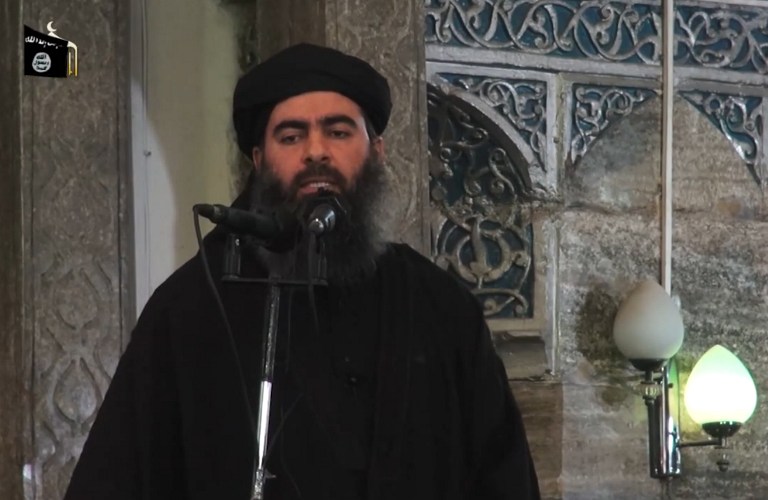 An image grab taken from a propaganda video released on July 5, 2014 by al-Furqan Media allegedly shows the leader of the Islamic State (IS) jihadist group, Abu Bakr al-Baghdadi, aka Caliph Ibrahim, adressing Muslim worshippers at a mosque in the militant-held northern Iraqi city of Mosul. Handout photo by al-Furqan Media/AFP 