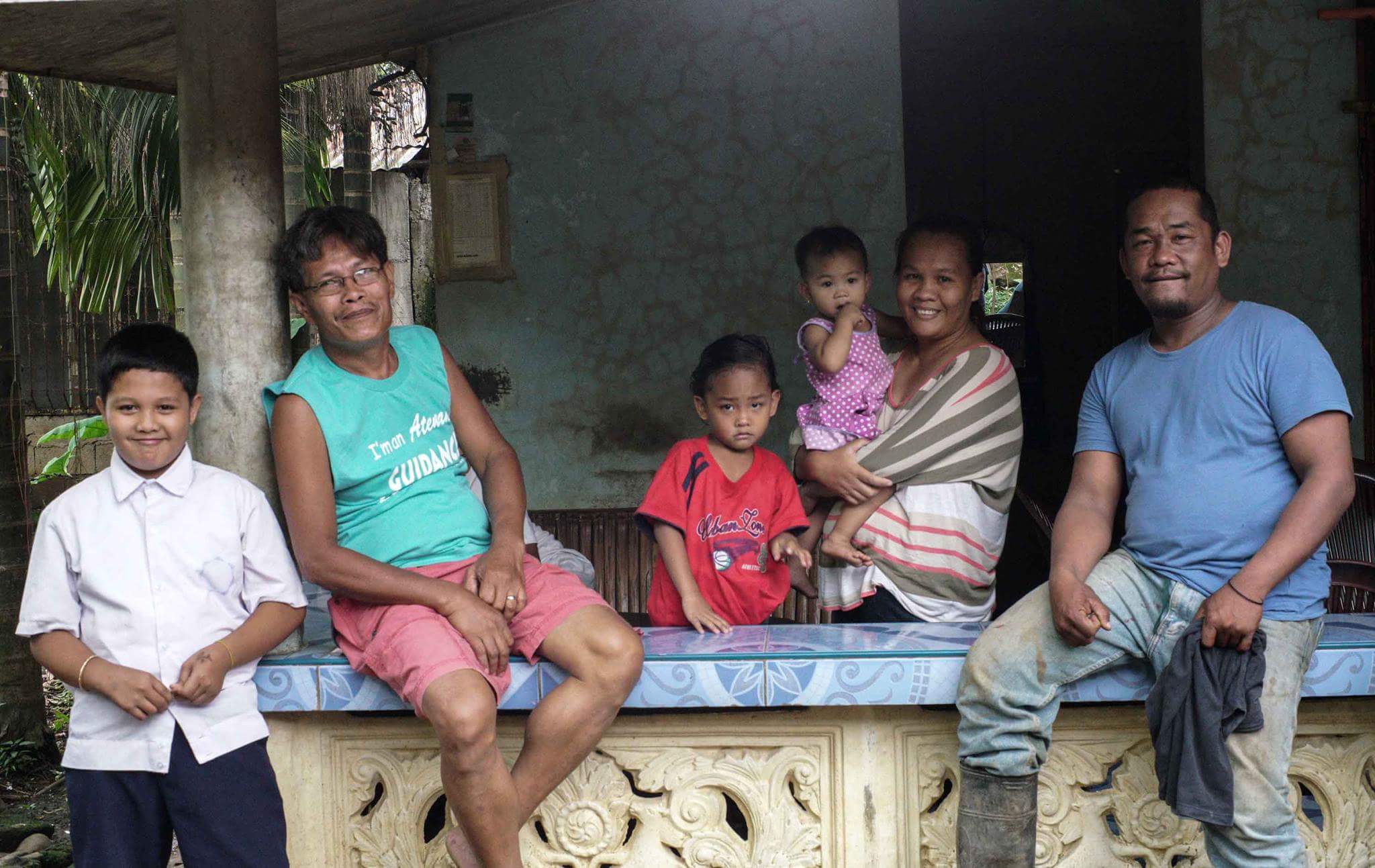 BACK TO BUKIDNON. Ronnel Samiahan (right) with his family in their home in Impasug-ong, Bukidnon. Photo by Linus Escandor   