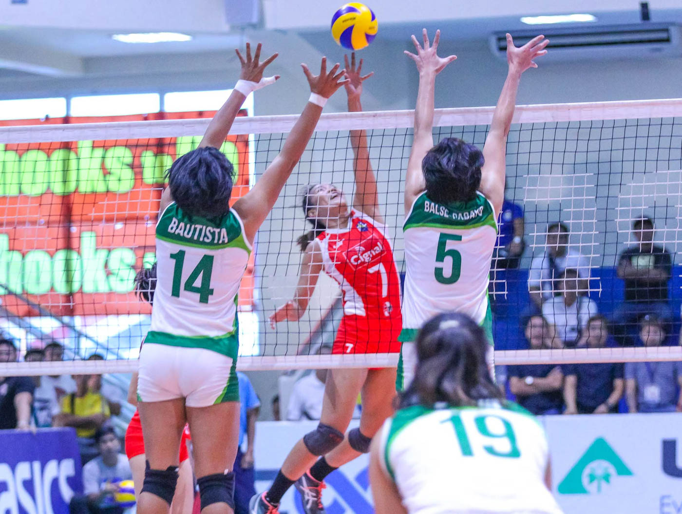 HITTING HIGH. Cignal's Mylene Paat goes for a kill over the outstretched arms of Smart-Army's  Nene Bautista and Mary Jean Pabayo. Photo from PSL 