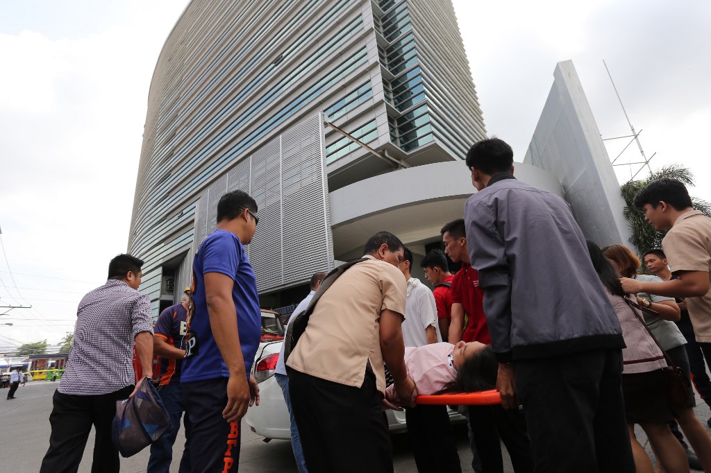 TREMOR. An office worker is carried on a stretcher after she fainted following an earthquake that rocked parts of Mindanao, including Davao City, on October 29, 2019.Photo by Manman Dejeto / AFP 