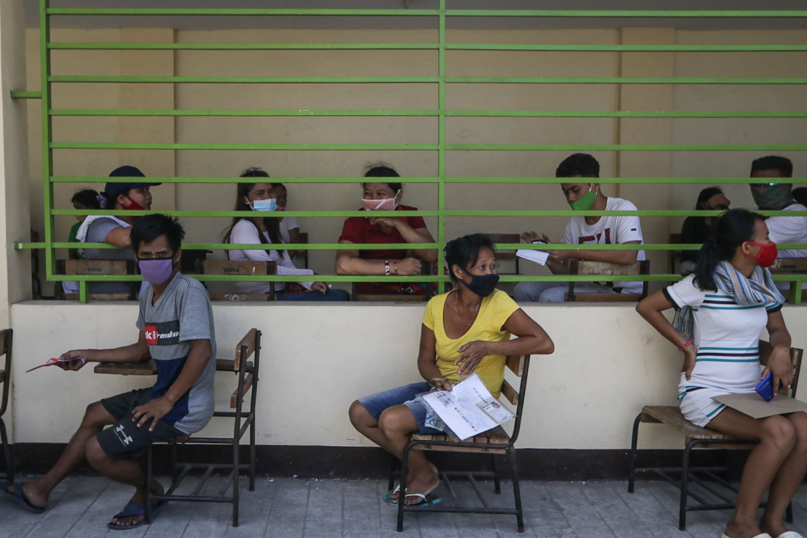WAITING. Residents of Baseco Compound wait in line for their financial assistance from the government's emergency subsidy program distributed by DSWD at the Baseco Elementary School in Tondo, Manila on May 2, 2020. Photo by KD Madrilejos/Rappler 