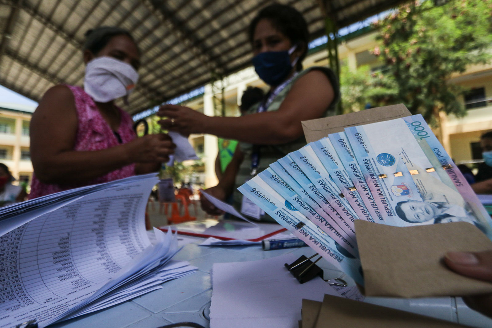SUBSIDY WOES. Residents of Baseco Compound wait in line for their financial assistance from the government's emergency subsidy program distributed by the DSWD on May 2, 2020. File photo by KD Madrilejos/Rappler   