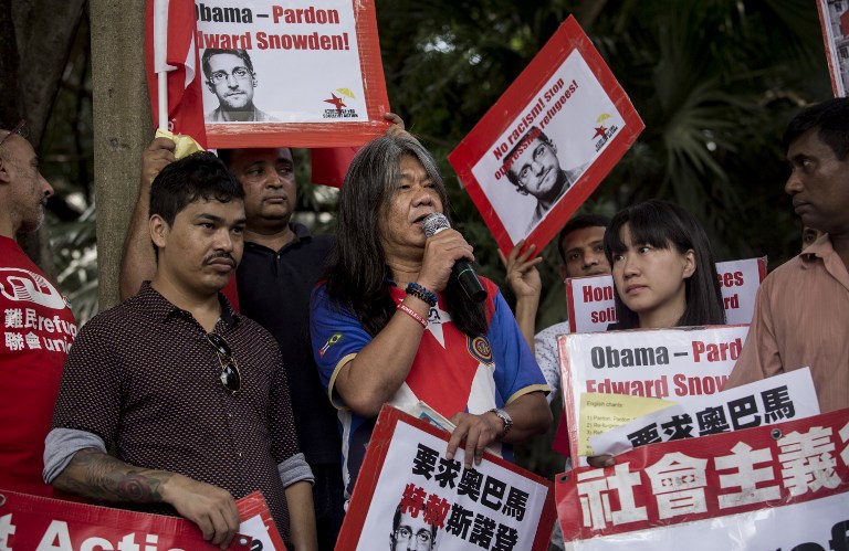 Legislative lawmaker Leung Kwok-hung (center), also known as "Long Hair," speaks outside the US Consulate during a rally organised by Socialist Action and League of Social Democrates calling for a presidential pardon for US whistleblower Edward Snowden and better rights for refugees in Hong Kong on September 25. Photo by Isaac Lawrence/AFP 