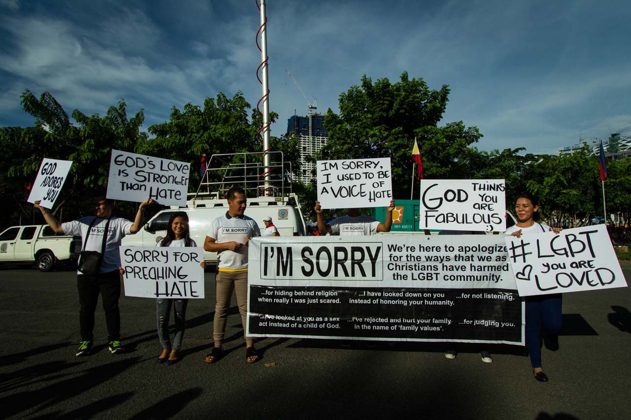 YOU ARE LOVED. Participants at the 'Love Wins' gathering in Manila hold up banners to support the LGBT community. Photo by Mark Saludes 